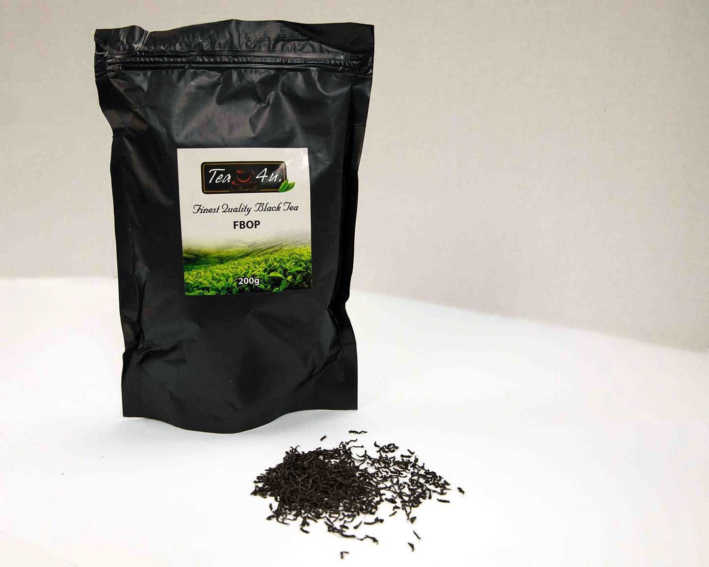 Bag of FBOP Loose Black 7 oz Ceylon Tea with a small amount of loose green tea leaves