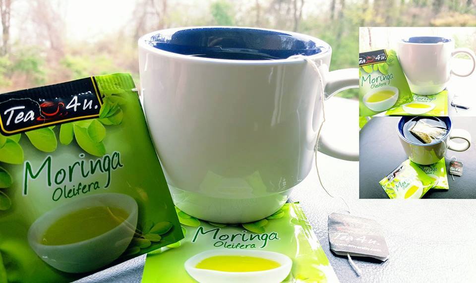 A cup filled with Tea4U Moringa Oleifera Energy Tea next to a green tea mug